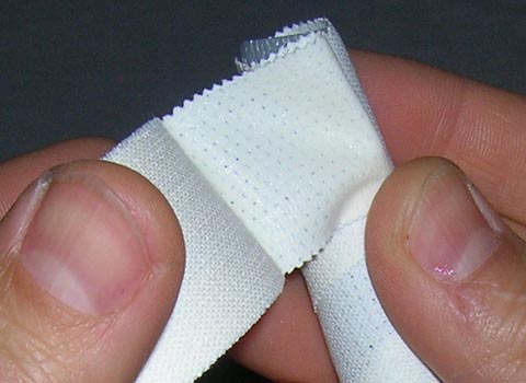 Step 2 for ear taping method: Reverse and start taping in the opposite direction, 
making sure that the sticky surface is now outside of the ear-stick